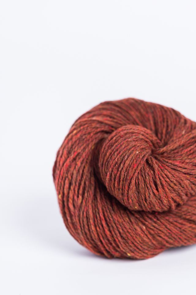 Rust red ball of Brooklyn Tweed Loft yarn. 