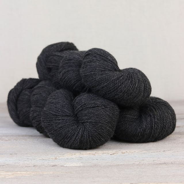 3 skeins of heathered black Fibre Co. Amble yarn. 