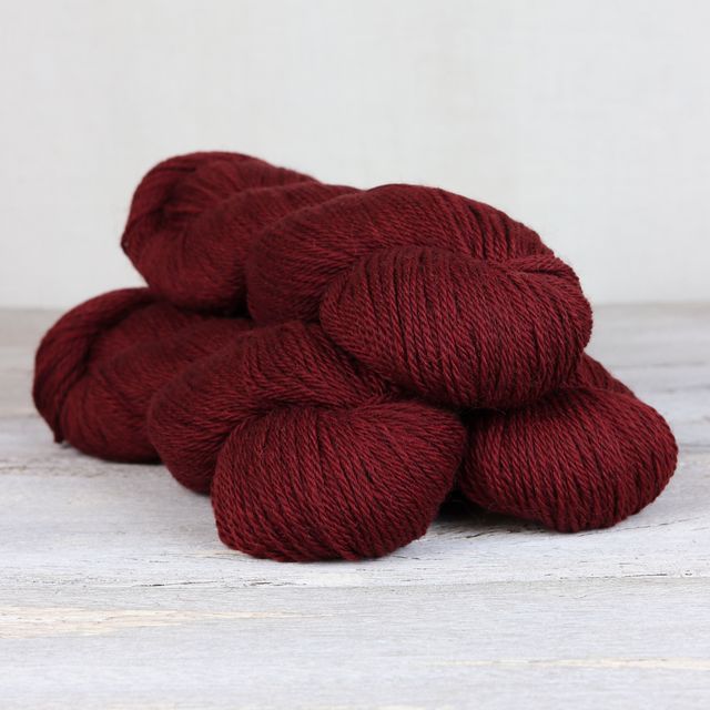 3 skeins of dark red Fibre Co. Cumbria yarn. 