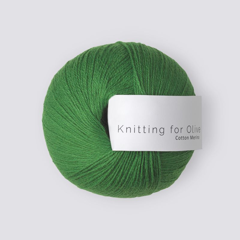 Green skein of yarn with a label on a white background