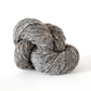 Skein of medium gray tweed Kelbourne Woolens Cricket yarn. 