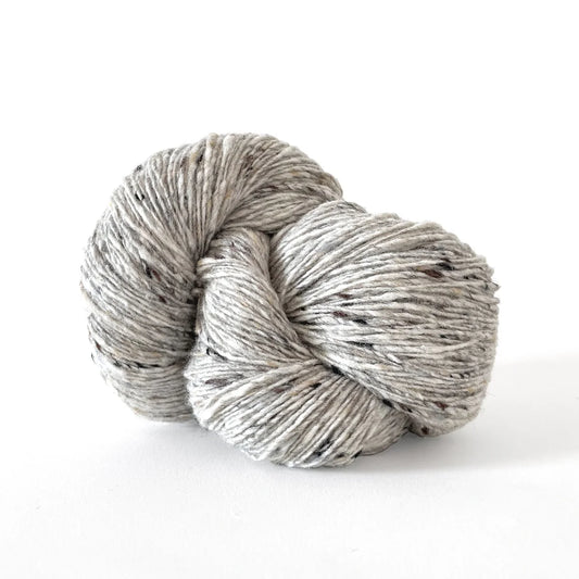 Skein of light gray tweed Kelbourne Woolens Cricket yarn. 