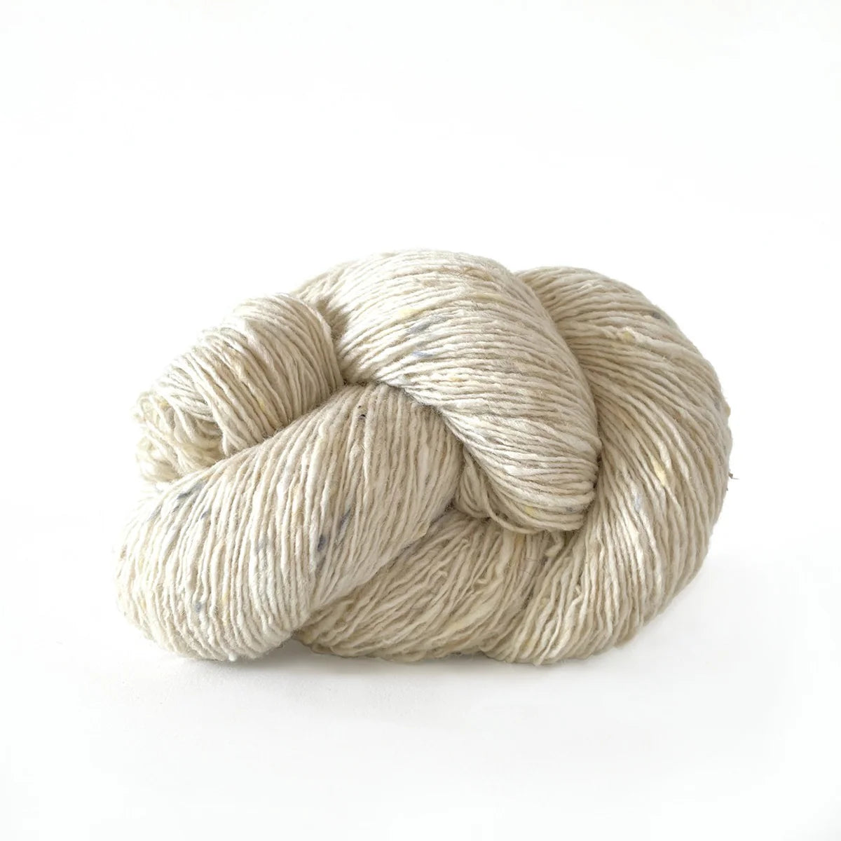 Skein of cream tweed Kelbourne Woolens Cricket yarn. 