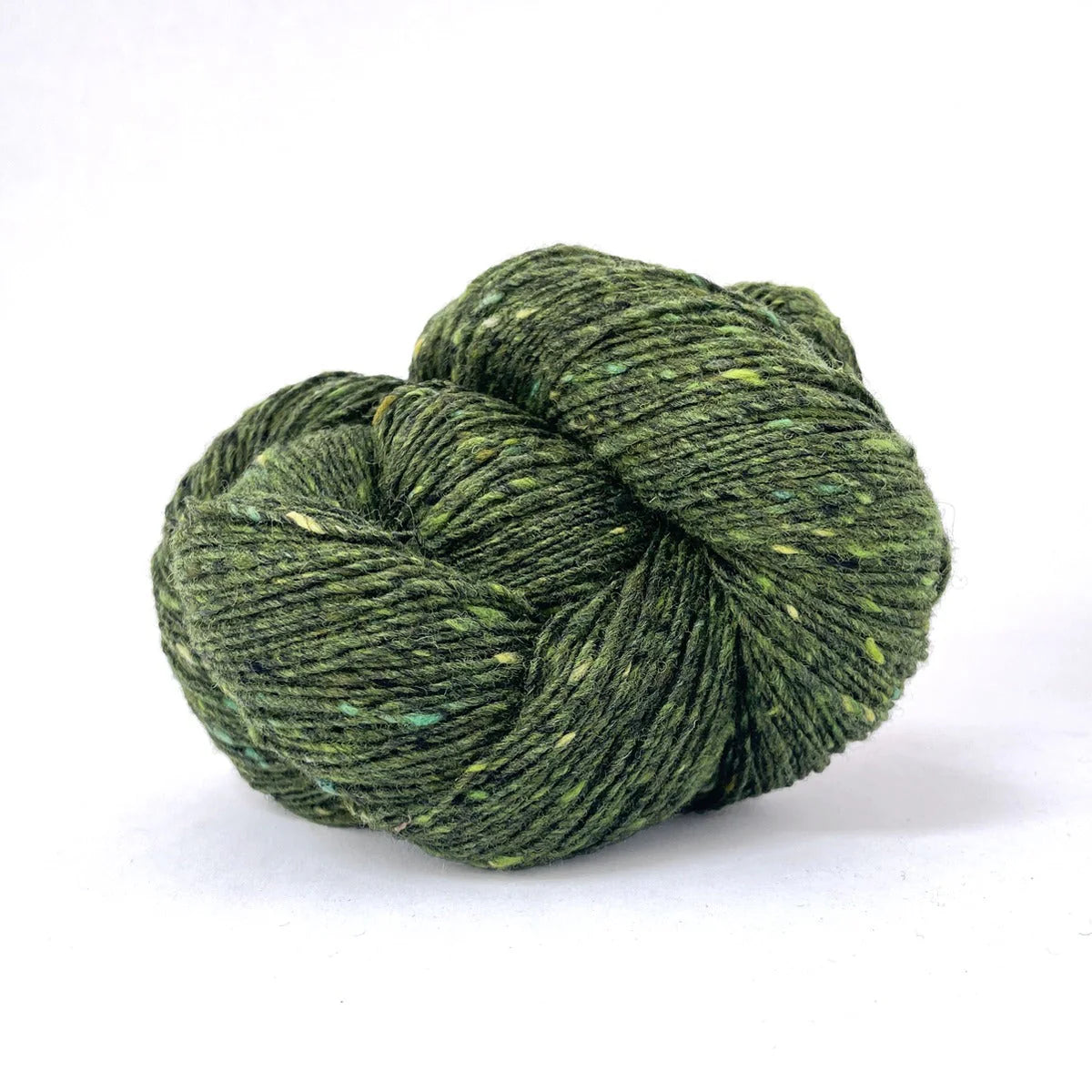 Skein of pine green tweed Kelbourne Woolens Cricket yarn. 