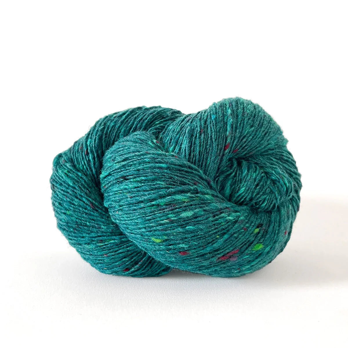 Skein of bright teal tweed Kelbourne Woolens Cricket yarn. 