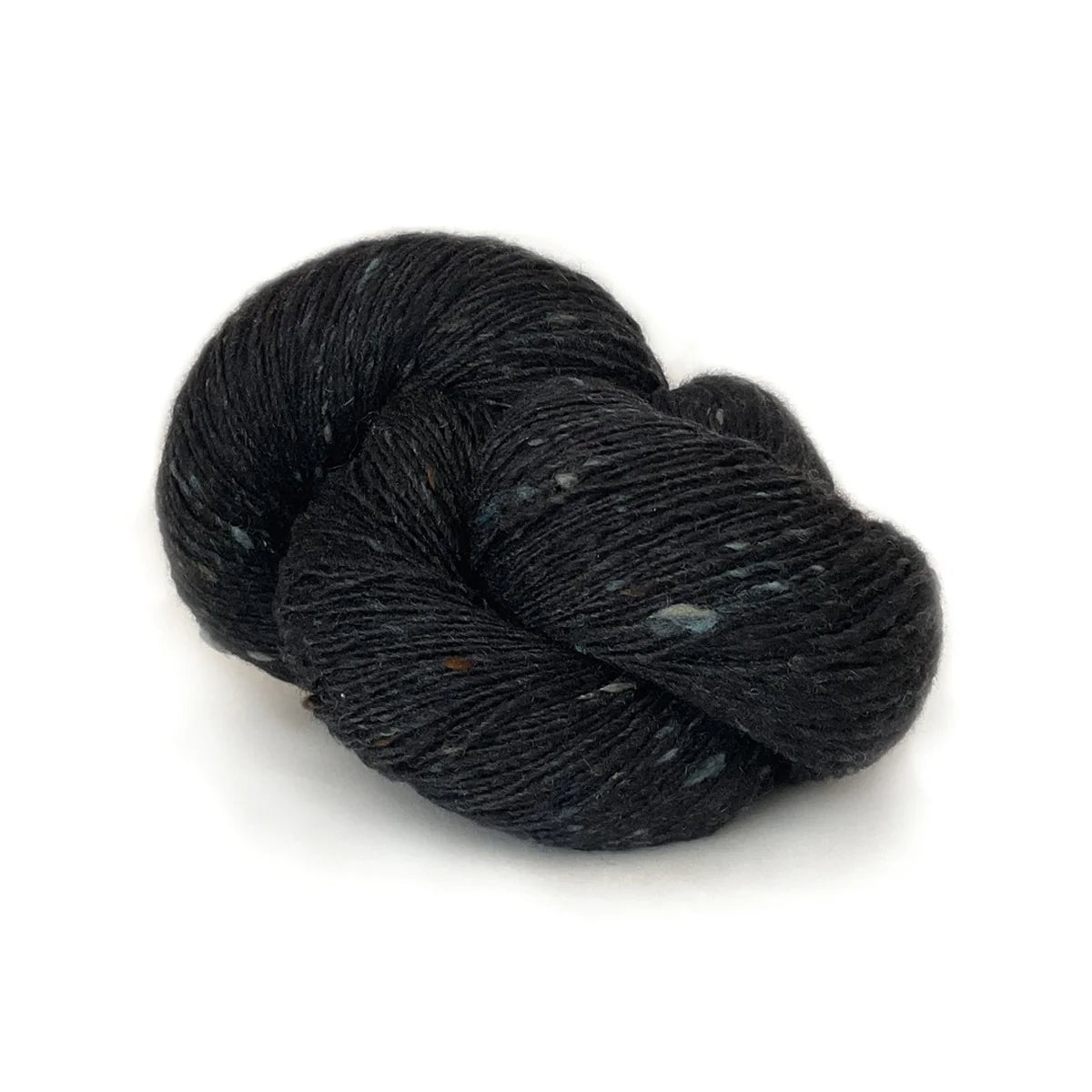 Skein of dark blue black tweed Kelbourne Woolens Cricket yarn. 