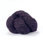 Skein of dark purple tweed Kelbourne Woolens Cricket yarn. 