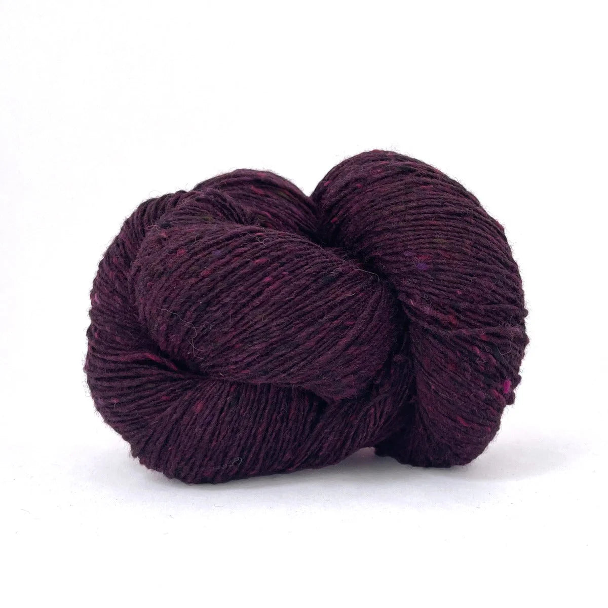 Skein of burgundy tweed Kelbourne Woolens Cricket yarn. 