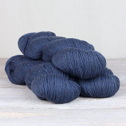 3 skeins of denim blue Fibre Co. Cumbria yarn. 