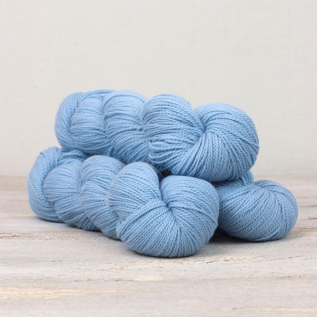 3 skeins of sky blue Fibre Co. Amble yarn. 