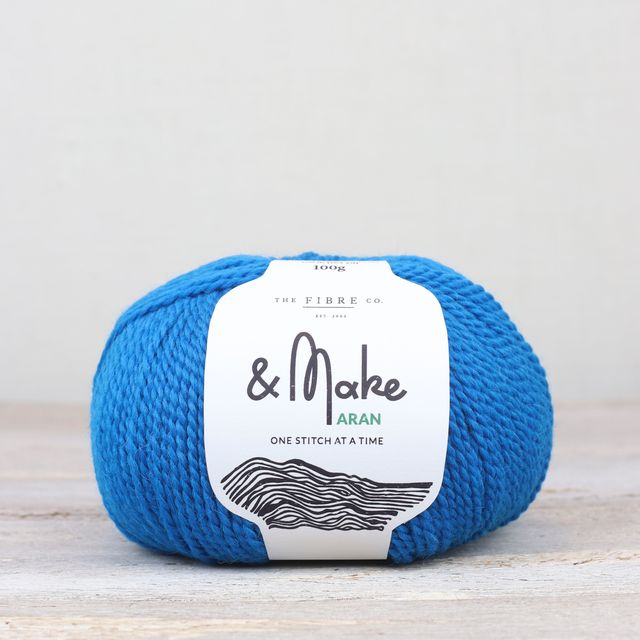 Bright blue ball of Fibre Co. & Make Aran yarn. 