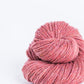 Salmon pink ball of Brooklyn Tweed Loft yarn. 