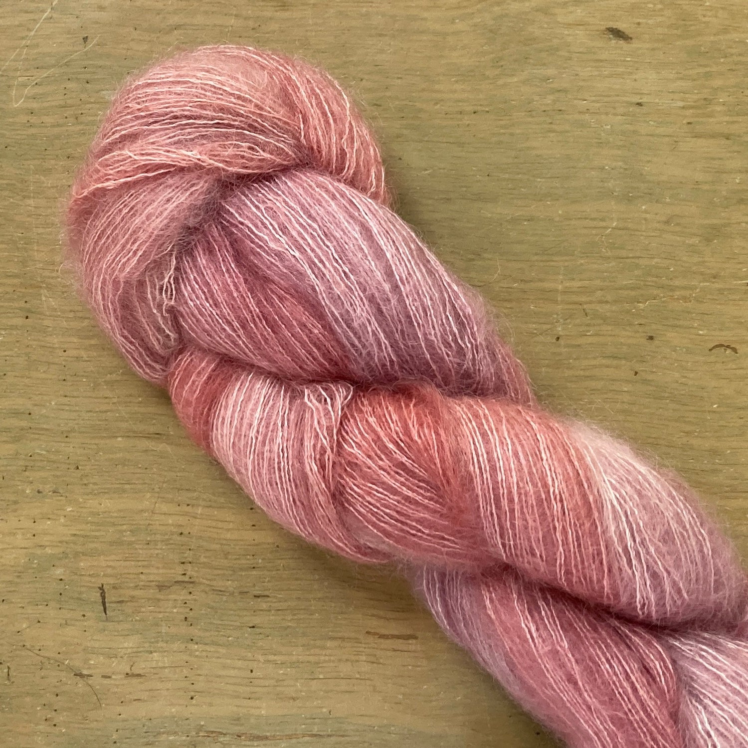 Rose Gold skein of Fleece Artist / Hand Maiden Superkid Silk yarn. 