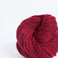 Deep red ball of Brooklyn Tweed Loft yarn. 