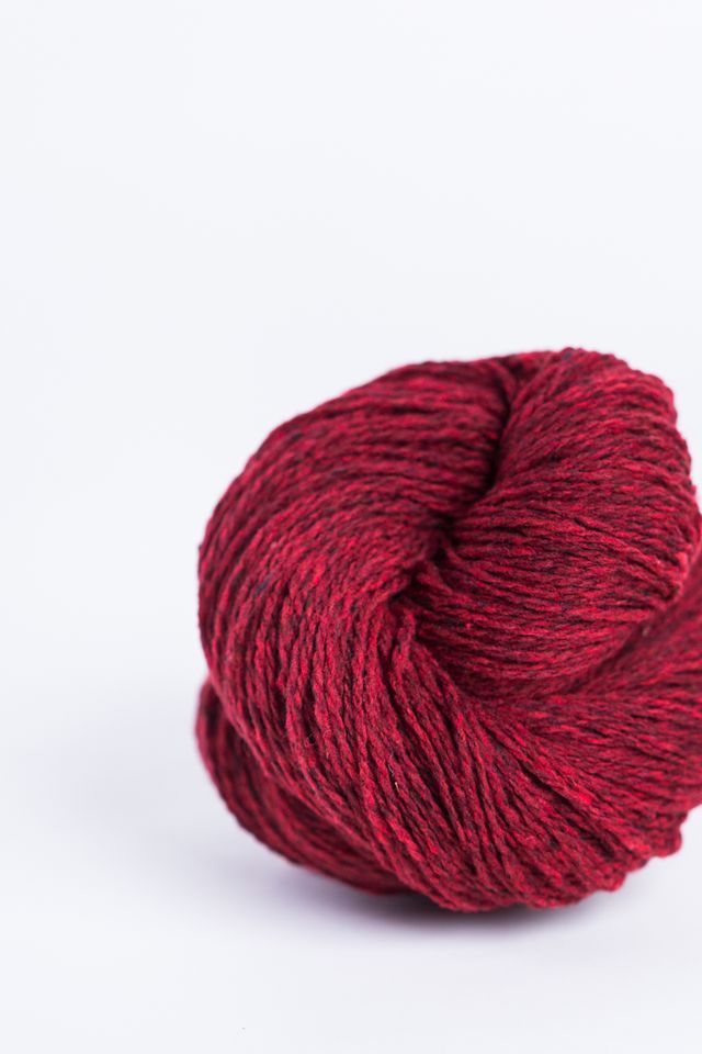 Deep red ball of Brooklyn Tweed Loft yarn. 