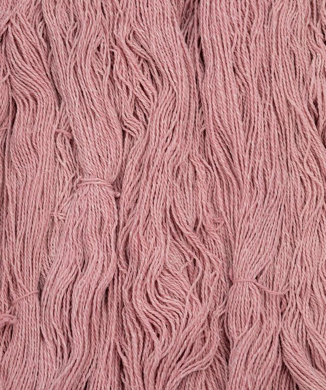 Skeins of light pink Brooklyn Tweed Dapple yarn. 