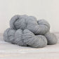 3 skeins of light heathered gray Fibre Co. Amble yarn. 