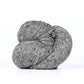 Skein of medium gray Kelbourne Woolens Lucky Tweed yarn. 