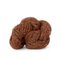 Skein of rust Kelbourne Woolens Lucky Tweed yarn. 