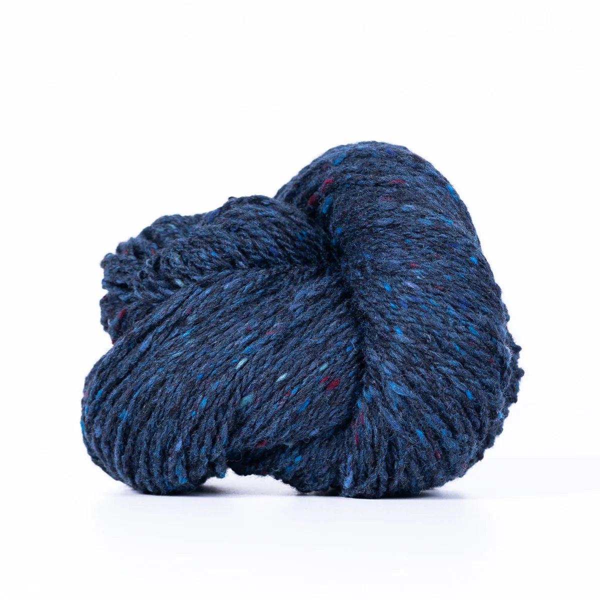 Skein of dark blue Kelbourne Woolens Lucky Tweed yarn. 