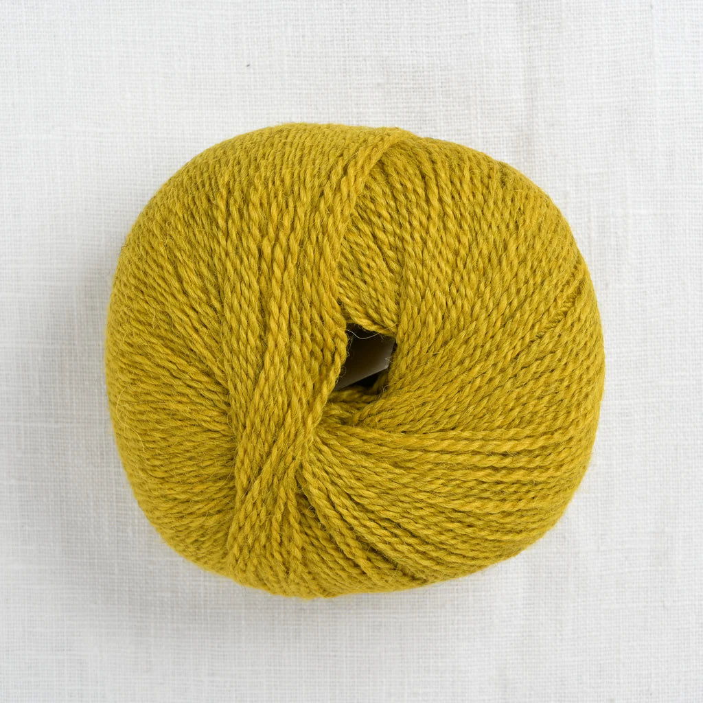 Ball of mustard yellow Pascuali Balayage yarn. 