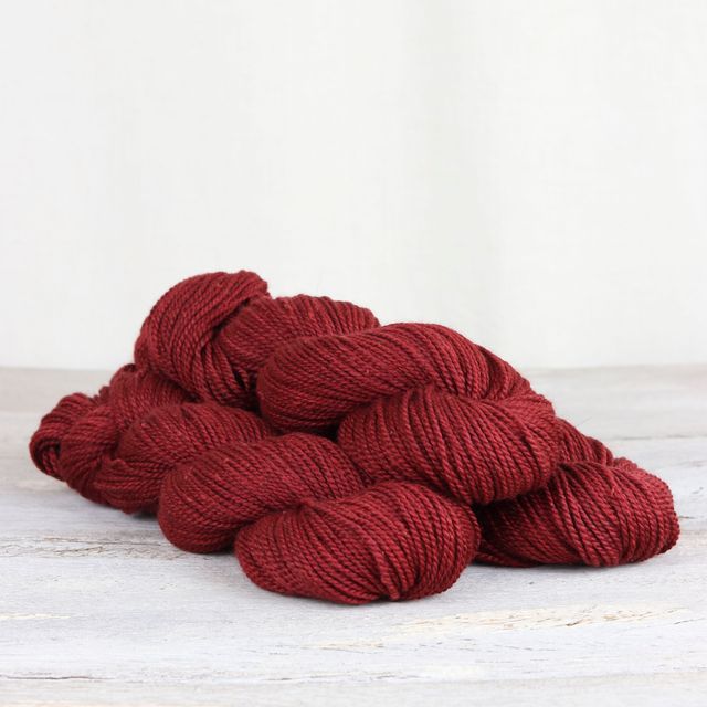 3 skeins of red Fibre Co. Acadia yarn. 