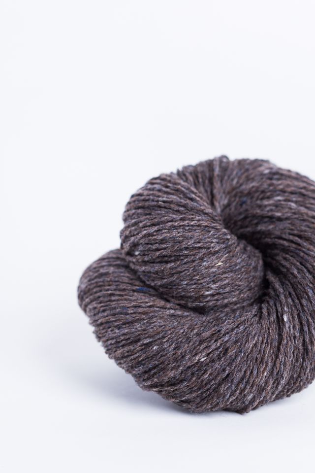 Dark heathered brown ball of Brooklyn Tweed Loft yarn. 