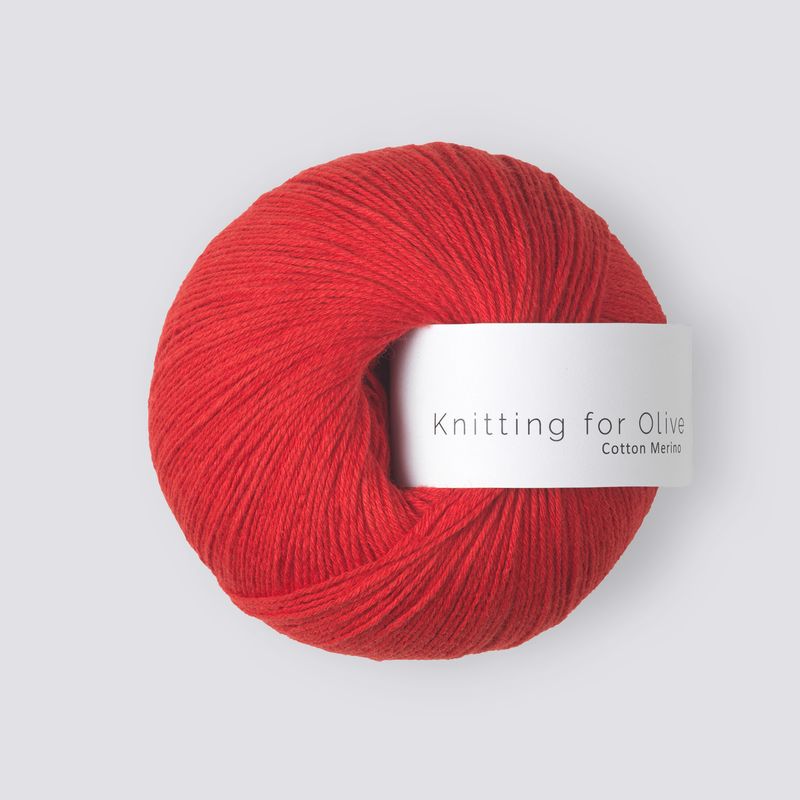 Red skein of yarn with a label on a light gray background