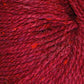 Close up on a red tweed ball of Queensland Kathmandu Aran yarn. 