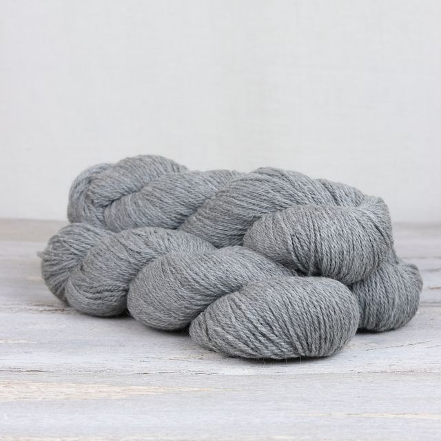 3 skeins of medium gray Fibre Co. Cumbria yarn. 