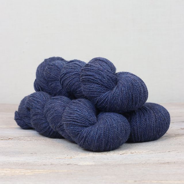 3 skeins of dark blue Fibre Co. Amble yarn. 