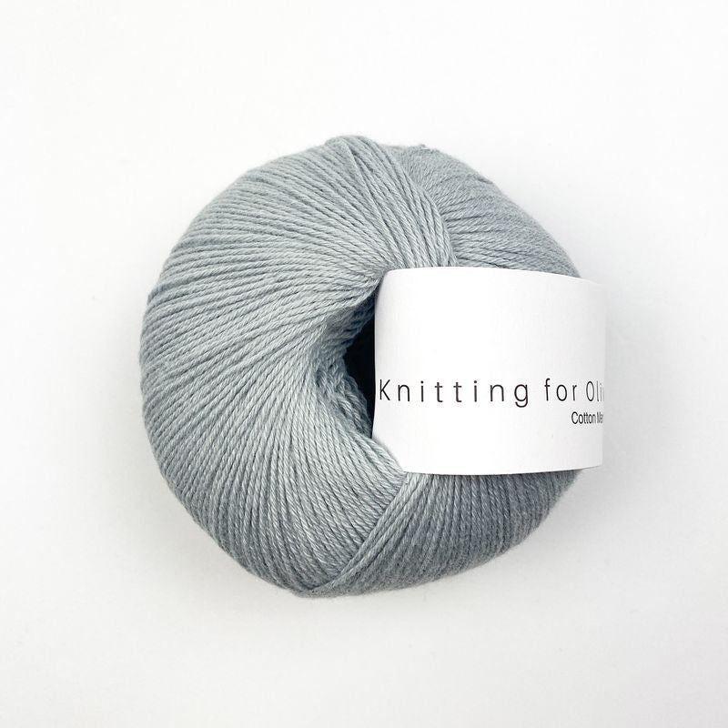 Gray blue skein of yarn with a label on a white background