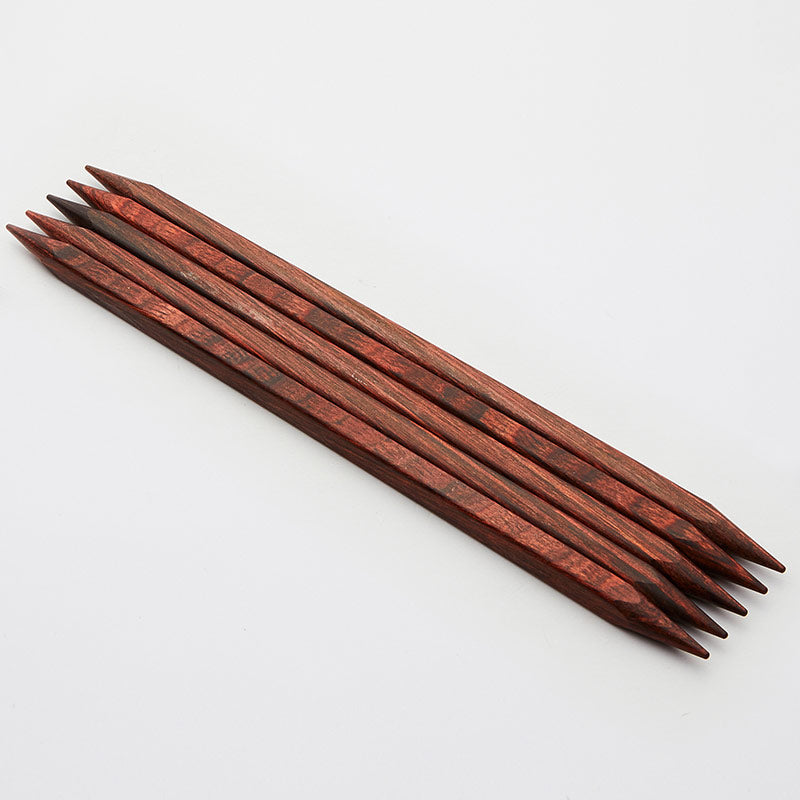 Set of 5 brown cubics double pointed needles. 