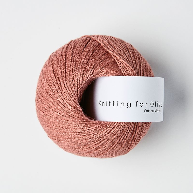 Ball of warm rose yarn with 'Knitting for Olive' label on a white background