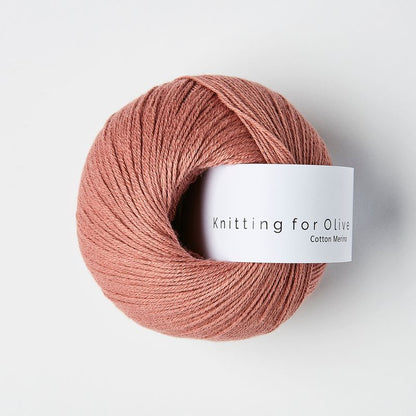 Ball of warm rose yarn with 'Knitting for Olive' label on a white background