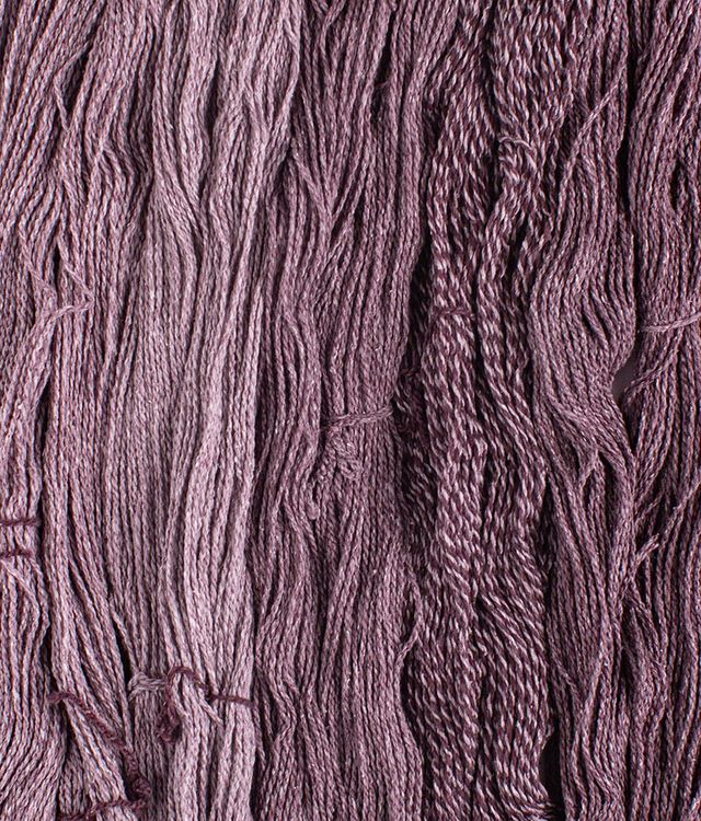 Skeins of fig purple Brooklyn Tweed Dapple yarn. 