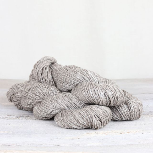 3 skeins of light gray Fibre Co. Acadia yarn. 