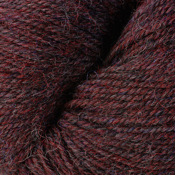 Close up on deep red purple skein of Berroco Ultra Alpaca yarn.