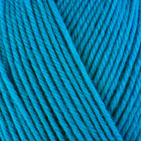 Close up on bright blue ball of Berroco Ultra Wool yarn.