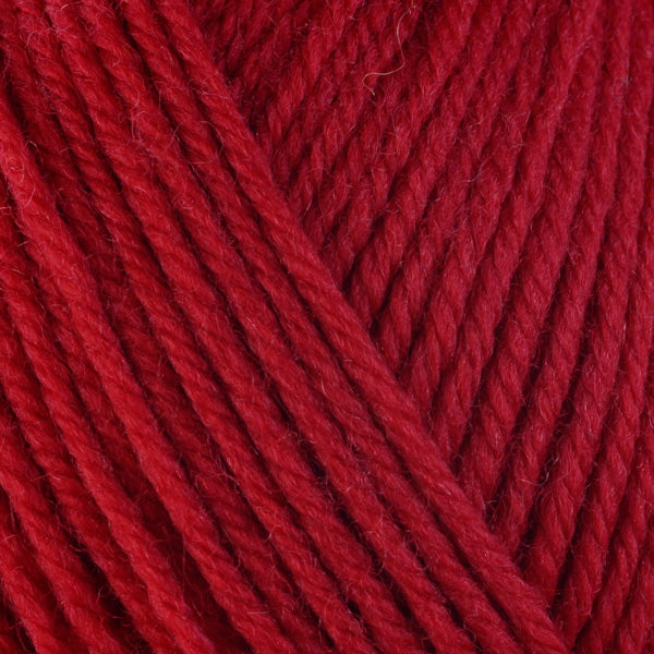 Close up on red ball of Berroco Ultra Wool yarn.