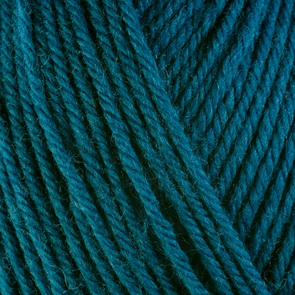 Close up on deep teal ball of Berroco Ultra Wool yarn.