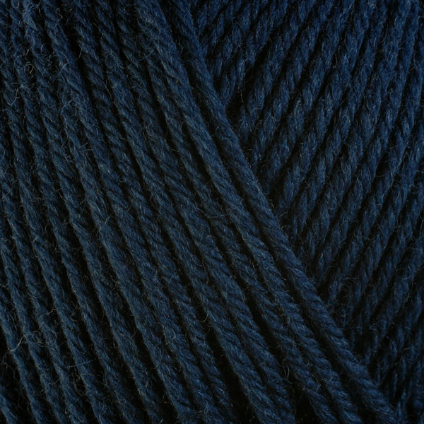 Close up on dark navy ball of Berroco Ultra Wool yarn.