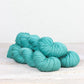 3 skeins of aqua Fibre Co. Acadia yarn. 