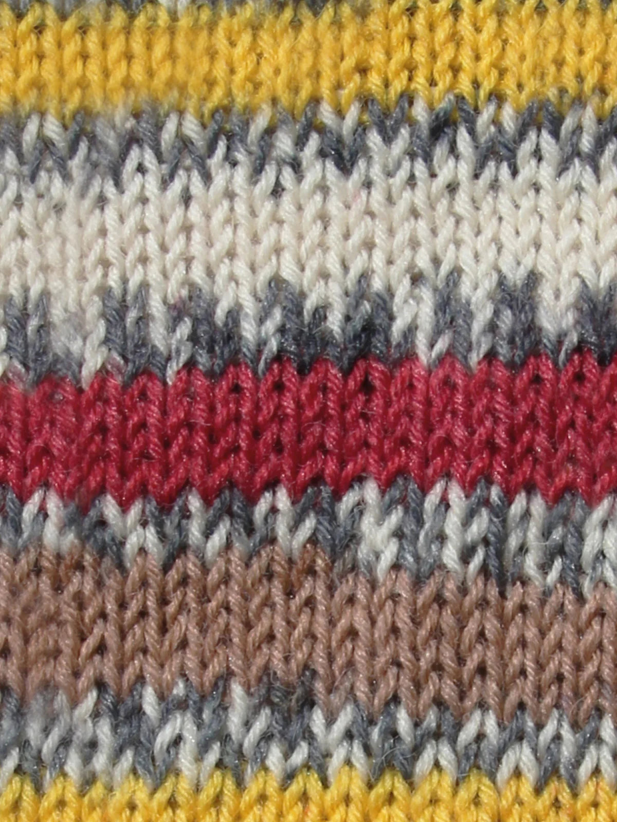 Close-up Goldfinch swatch - a knitted fabric with irregular multicolored stripes. 