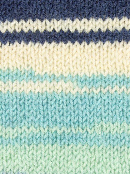 Close-up of knitted fabric with blue, white, and teal stripes that have a gradient effect.