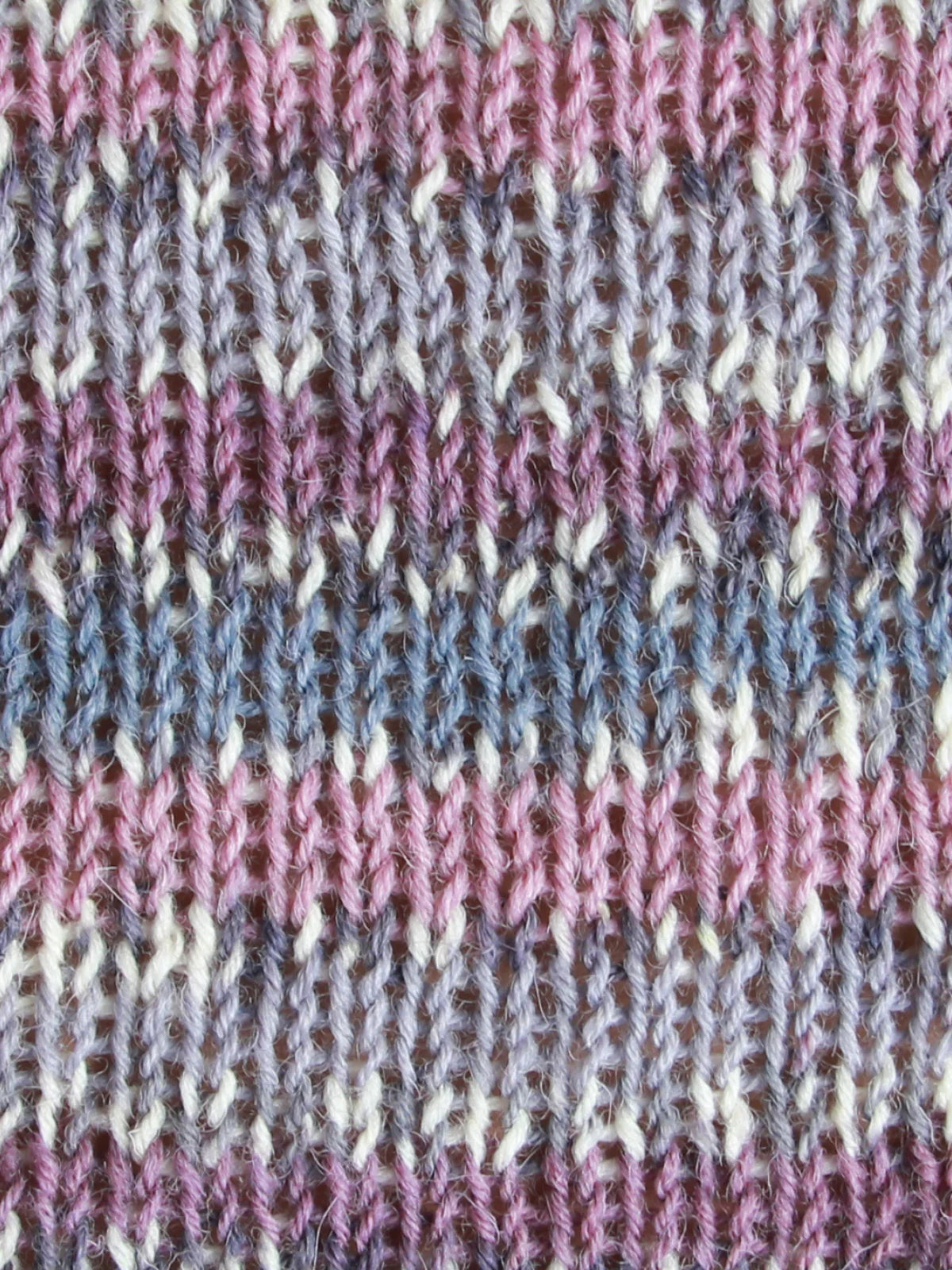 Close-up of WYS Signature 4ply swatched fabric in color Woodpigeon with irregular stripes.