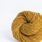 Mustard yellow ball of Brooklyn Tweed Loft yarn. 