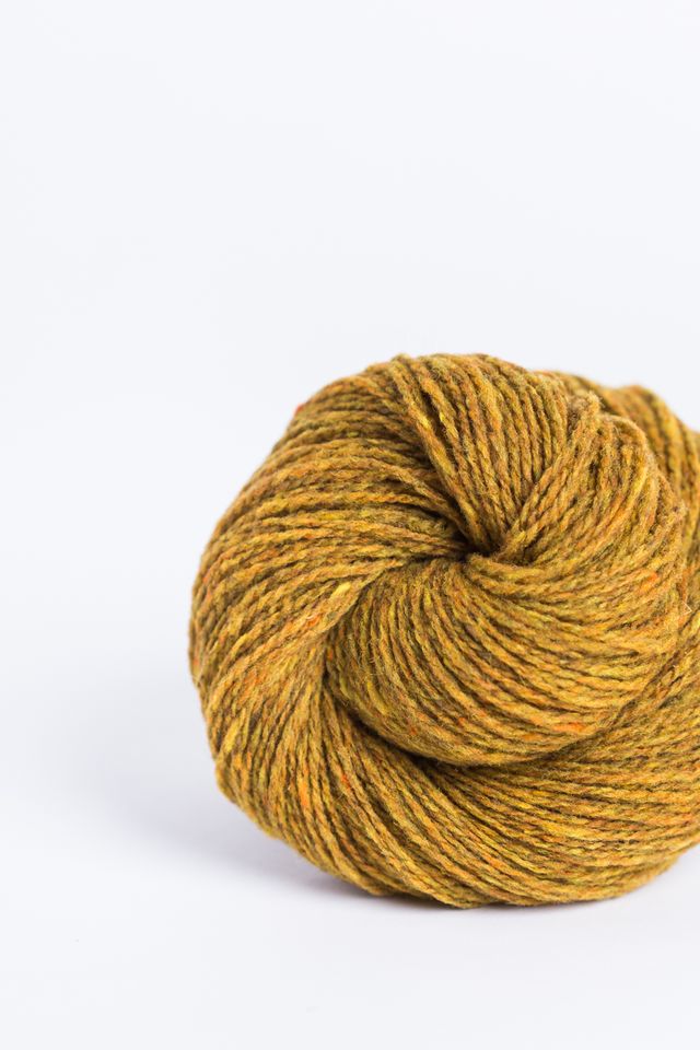 Mustard yellow ball of Brooklyn Tweed Loft yarn. 