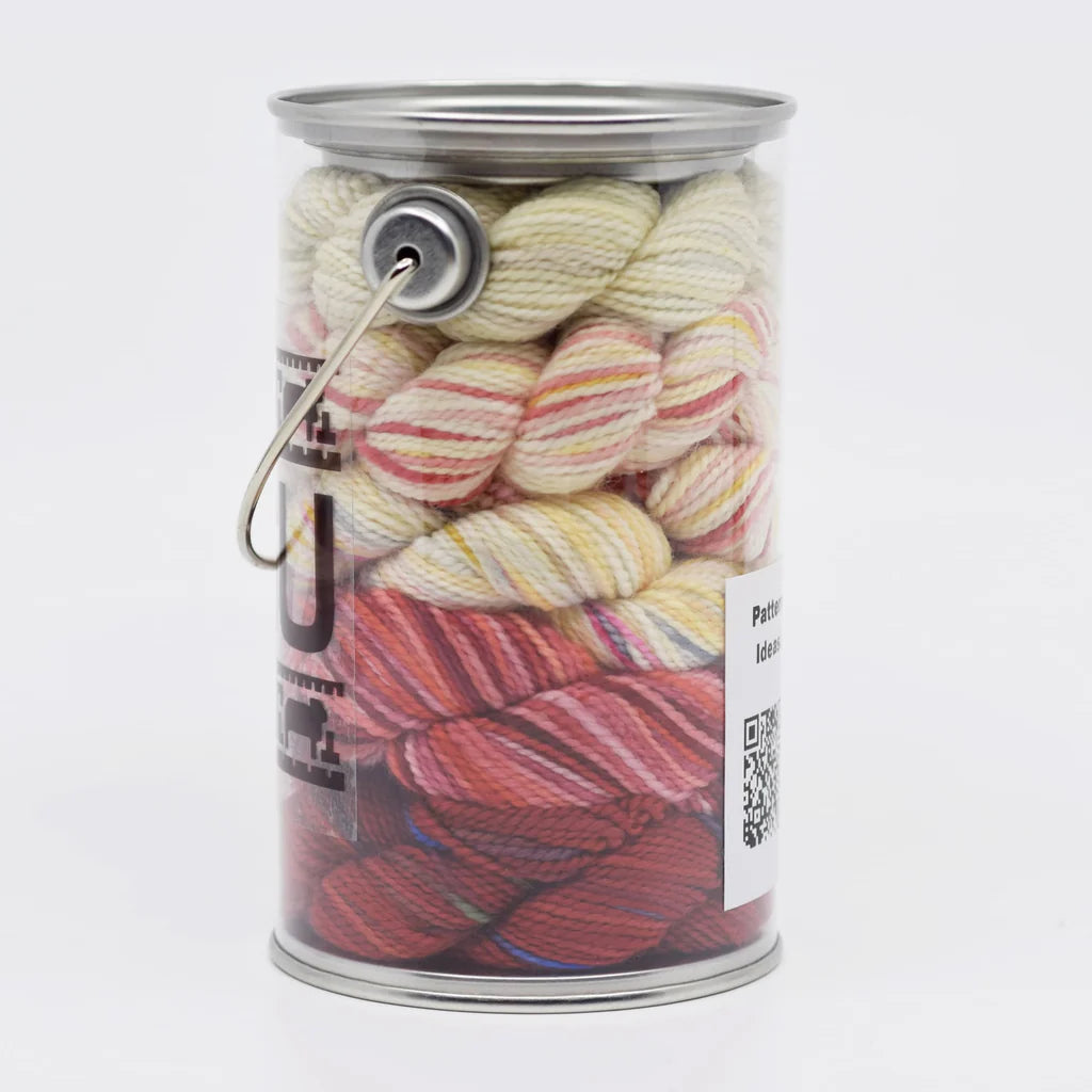 Clear plastic container filled with colorful hand dyed yarn. 