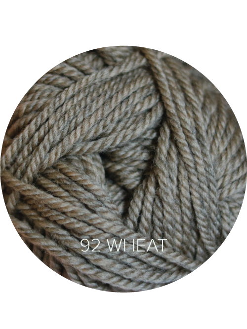 Close up on a beige ball of Ewe Ewe Heather’s Heathers yarn. 